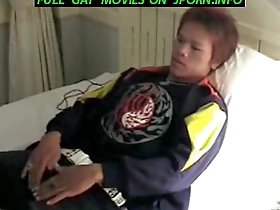 Gay Asian twink masturbates while watching TV.