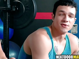 Muscular men engaging in gay sex at the gym