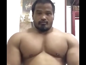 A hunk of a man, Thai bodybuilder showing off his muscles.