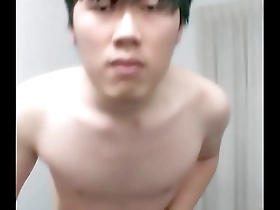 A solo boy of Asian descent pleasuring himself.