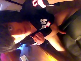 A young and handsome Asian man masturbates through his t-shirt.