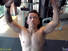 A handsome Asian man prepares for a nipple play session at the gym.