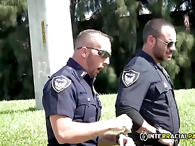 Gay police officers rough up a car thief and give him anal sex with a big cock.