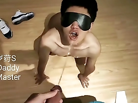 Young Asian boy as a slave to serve his master in a piss fetish scene.