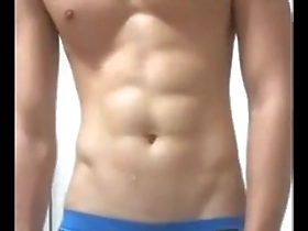 Young Asian man with a six pack showing off his solo skills.